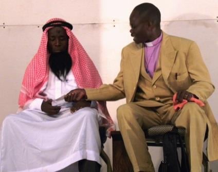In a scene from the play Gateway to Eternity , the false prophet Rev. Dr. Victor Victorius offers Haji money to pretend that he has become one of his converts. The play was presented as a project for the course Introduction to Drama.